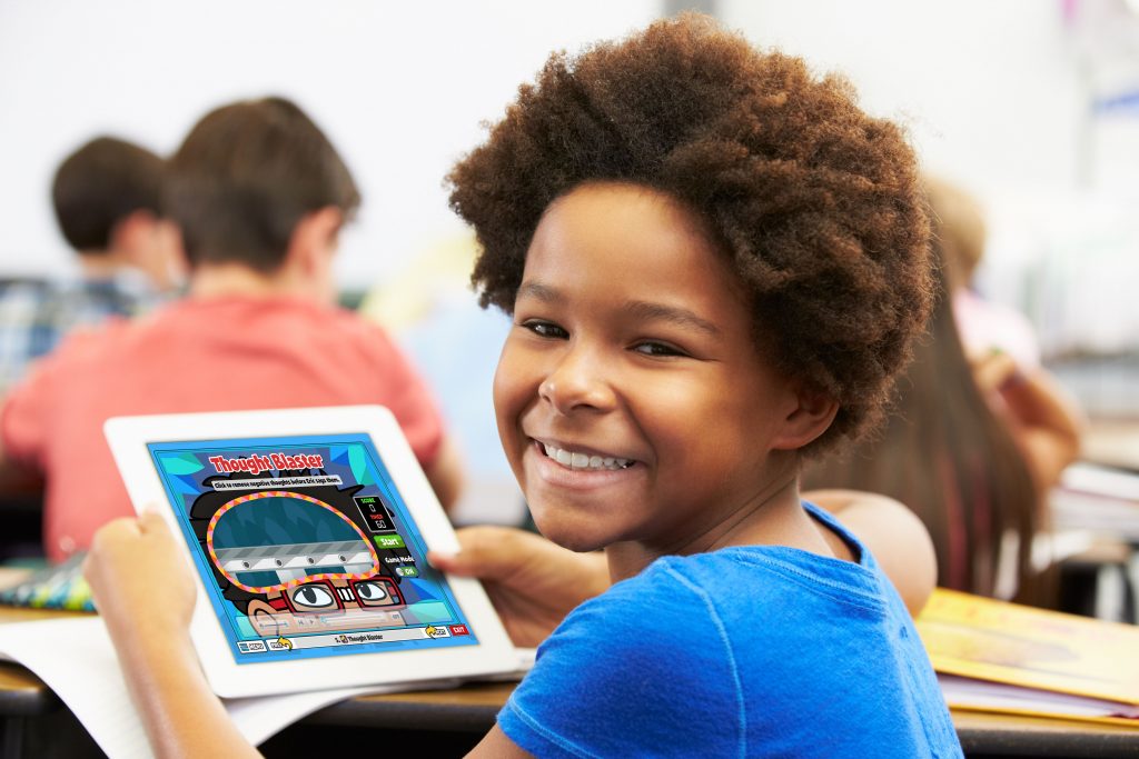 Elementary student using a tablet to develop social-emotional skills in the classroom.