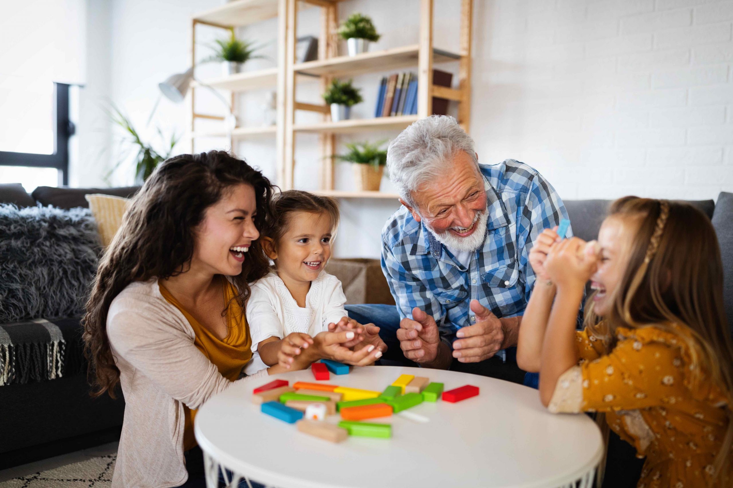 Happy family having fun time at home. Grandfather playing with kid