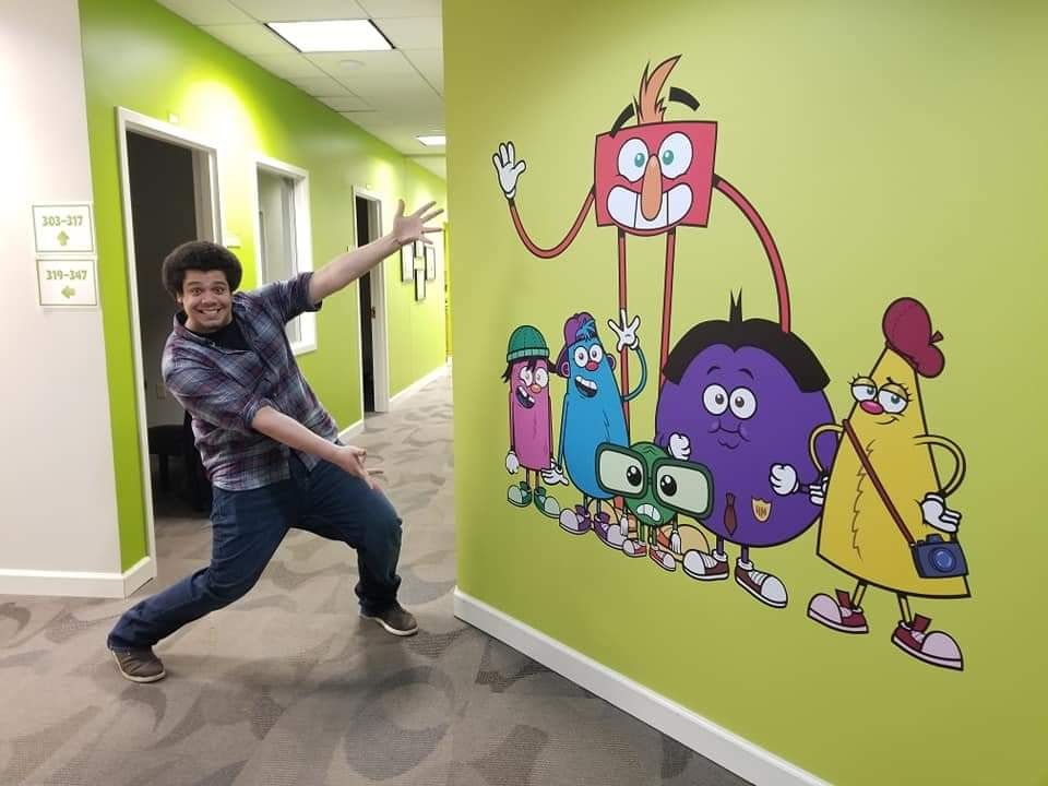 84494045_10221246740386833_9142197605931941888_n-Ryan-Brown – QuaverEd Ryan Brown poses proudly near some of his work at QuaverEd headquarters in Nashville!