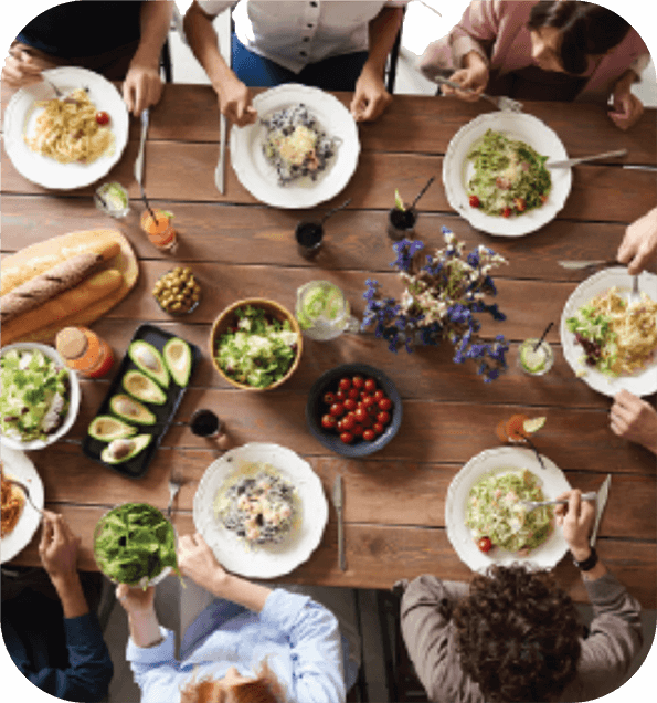 ThemeBlocks_grid_noText_Communities – QuaverEd A table of people enjoying a meal from overhead representing the theme Communities from Quaver Pre-K