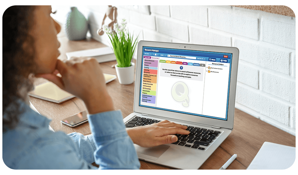 Teacher using a laptop with Quaver Music Integration's Resource Manager.
