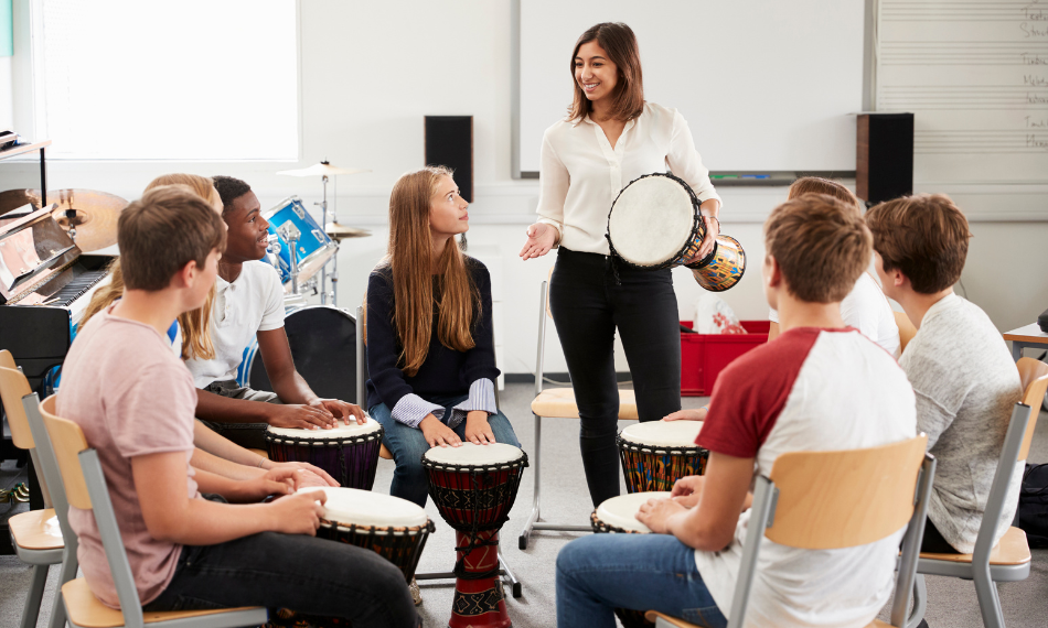 A diverse group of young adults playing drums.