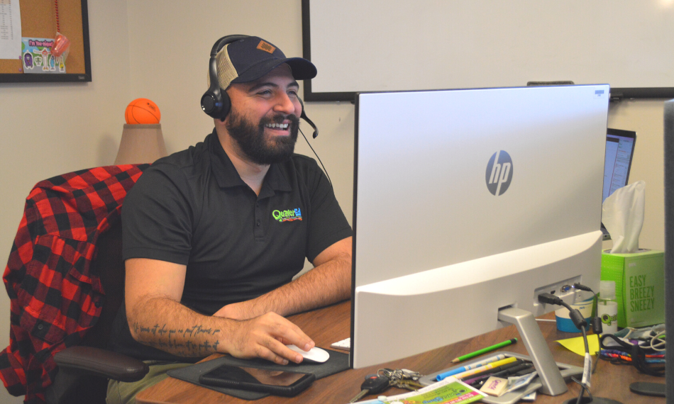 Our Services_CustomerSupport – QuaverEd A man in customer support helping a Quaver Ed user