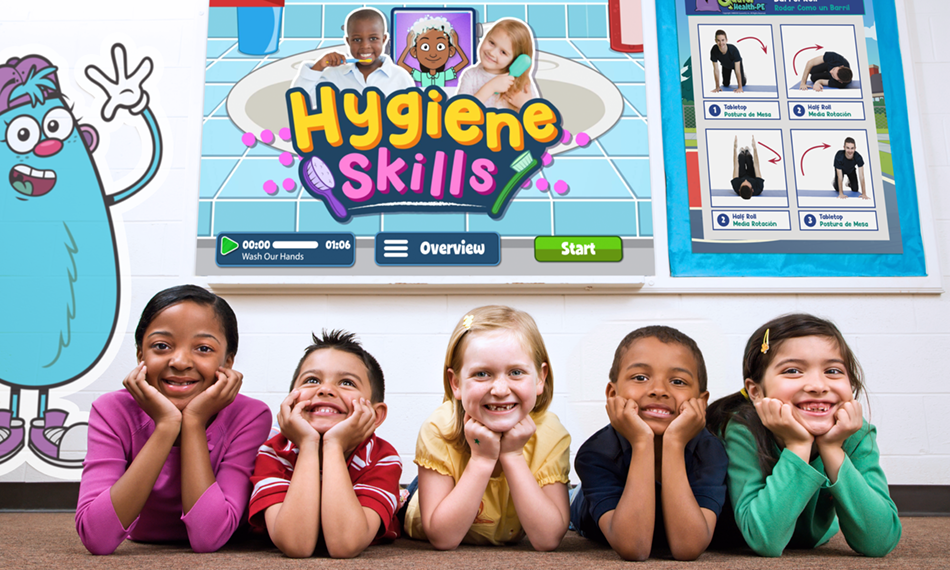 QHPE-Hygiene – QuaverEd Children smiling in a classroom with a Quaver Health PE hygiene skills video on a smart board behind them
