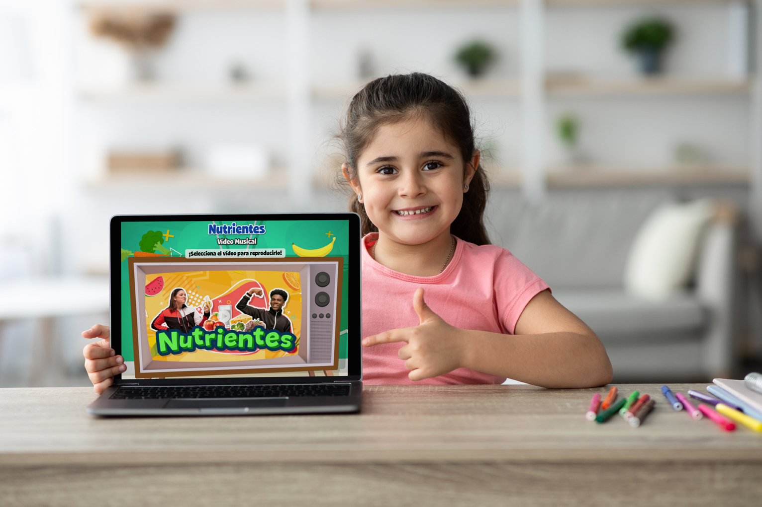 Student smiling behind a laptop showing Spanish resources within Quaver Health PE