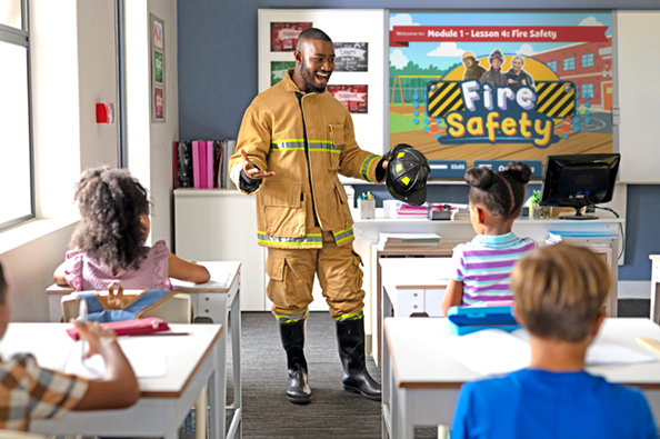 Fireman and students in a class participating in a Quaver Health PE fire safety community project